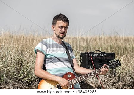 The Young Man On The Field, The Musician With The Guitar And Amp, The Concept Of Music And Art