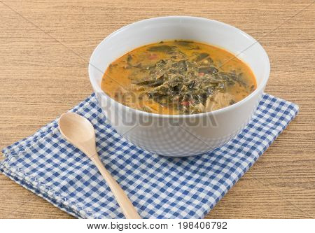 Thai Cuisine and Food A Bowl Thai Spicy Coconut Milk Cream Based Curry with Cassia Leaves and Grilled Beef Fillet.