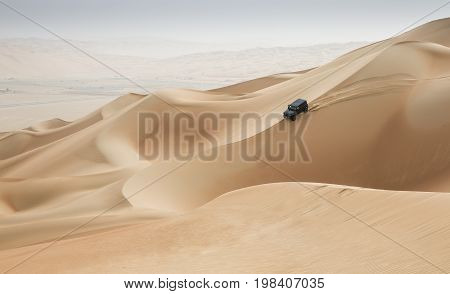 Car Driving In Rub Al Khali Desert At The Empty Quarter, In Abu Dhabi, Uae