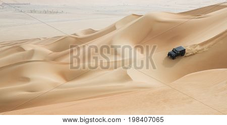 Car Driving In Rub Al Khali Desert At The Empty Quarter, In Abu Dhabi, Uae