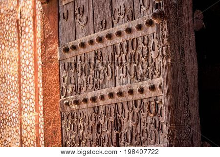 Door with horseshoes at antient abandoned city of Fatehpur Sikri n the Agra District of Uttar Pradesh, India.