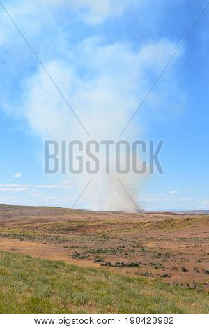 Prairie Fire in Wyoming. Smoke rises from a small brush fire.