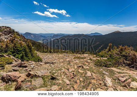 Trail Ridge Road is the name for a stretch of U.S. Highway 34 that traverses Rocky Mountain National Park from Estes Park Colorado in the east to Grand Lake Colorado in the west offering stunning mountain views.