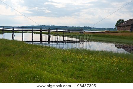 Wooden footbridge over pond.Kenozerye. Arkhangelsk region Russia