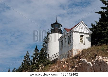 Bass Harbor lighthouse sits atop a rocky cliff in Acadia National Park in Maine.