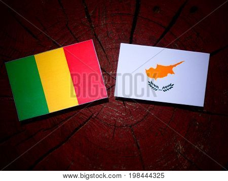 Malian Flag With Cypriot Flag On A Tree Stump Isolated