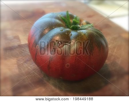 Chef's Choice Gourmet Garden Cultivated Red and Green Heirloom
Tomato on Cutting Board, Ripe and Washed