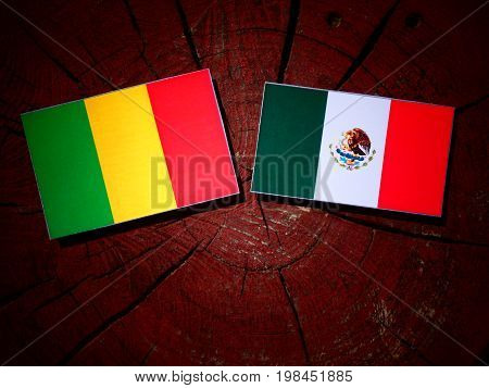 Malian Flag With Mexican Flag On A Tree Stump Isolated