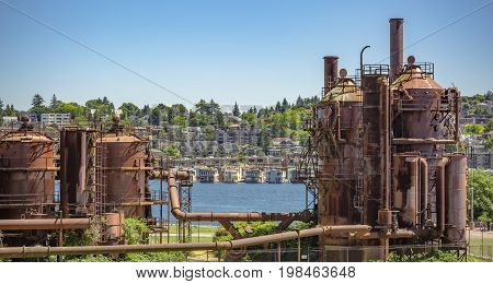 Abandoned Machines And Storage Units In A Gas Industry At Gas Works Park Seattle With Homes Behind
