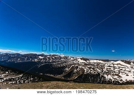 Trail Ridge Road is the name for a stretch of U.S. Highway 34 that traverses Rocky Mountain National Park from Estes Park Colorado in the east to Grand Lake Colorado in the west offering stunning mountain views.