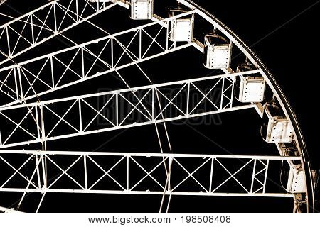 Low angle view of ferris wheel against dark night sky