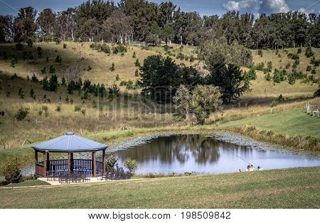 Wooden gazebo standing by pond at Ocean View Winery Queensland Australia