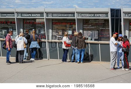 PETERHOF/ RUSSIA - JULY 2, 2017. People stand near the ticket office to buy a ticket on the hydrofoil boat (meteor) from the Park of Petergof in the direction to the center of St. Petersburg. Russia