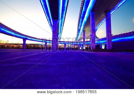Empty Road Floor With City Viaduct Bridge Of Neon Lights Night