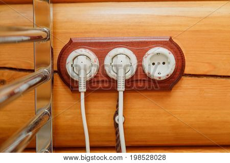 Old fashioned electricity switches, socket, electric wire in on a wooden wall
