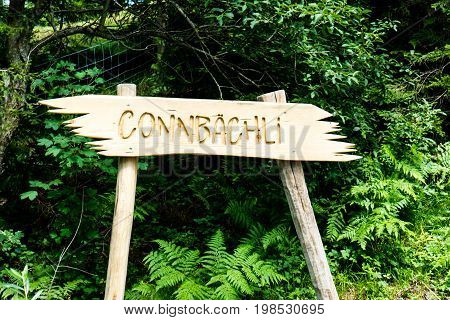 wooden sign Connbaechli in flims hiking caumasee