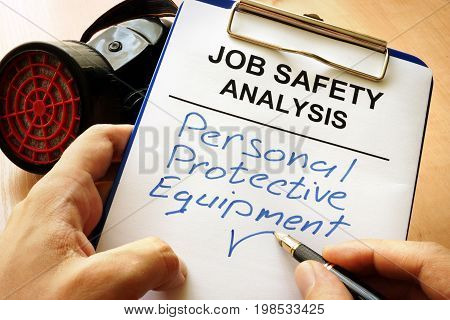 Man is writing words Personal protective equipment (PPE).