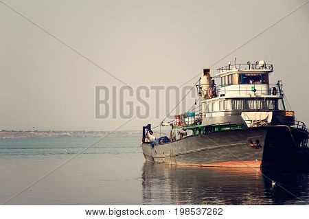 Large fish processing boat in the deep water dock on a sunny summer day. photo
