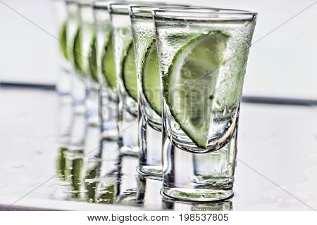 Cocktail. Vodka, gin tequila with lime glass