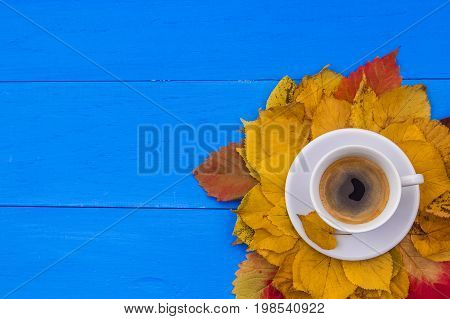 Creative autumn layout with leaves and coffee cup. Flat lay. Fall cocncept.