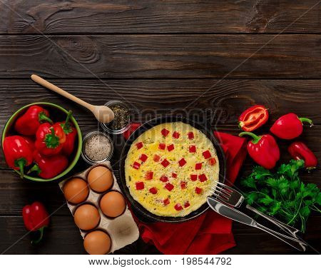 Breakfast. Cooking of an omelette with sweet red bolgarian peppers. Selective focus.