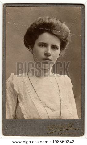 WIEN, AUSTRIA-HUNGARY - CIRCA 1915: Vintage cabinet card shows woman with Victorian and Edwardian ha