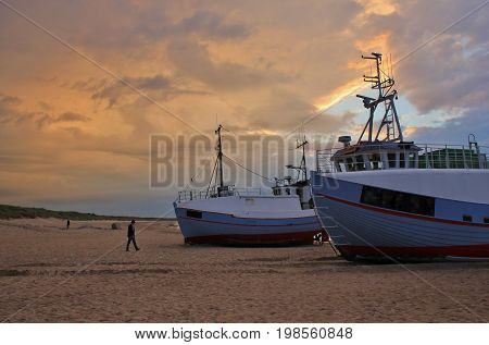 Moody sky over fishing boats at the Thorup Strand Denmark.