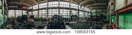 Panoramic shot of abandoned industrial factory in Efremov, Russia. Panorama of a large workshop with old and rusted equipment, toned