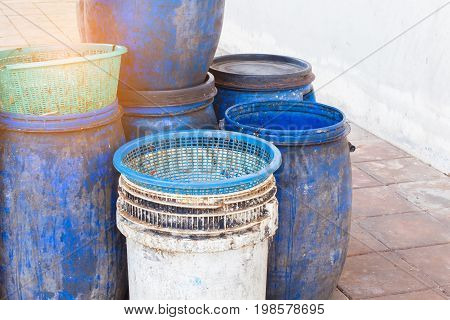 dirty white and blue garbage bin with copyspace on the right