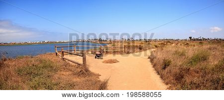 Bench Overlooking The Peaceful And Tranquil Marsh Of Bolsa Chica Wetlands