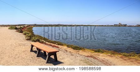 Bench Overlooking The Peaceful And Tranquil Marsh Of Bolsa Chica Wetlands