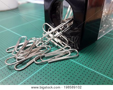 A lot of paper clips Being poured out of storage.
