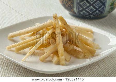 Dish with Japanese pickled burdock roots called gobo
