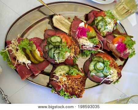 Selection of Smoerrebroed Danish open faced sandwiches on a serving plate