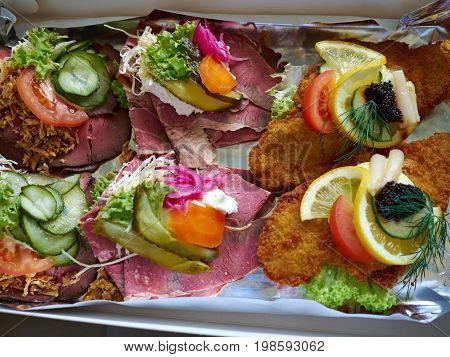 Selection of Smoerrebroed Danish open faced sandwiches on a serving plate
