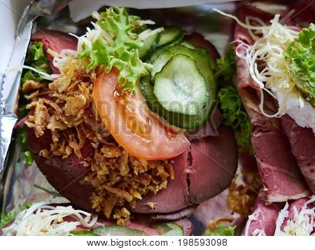 Selection of Smoerrebroed Danish open faced sandwiches on a serving plate