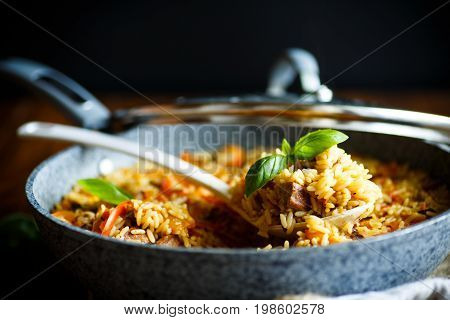 Pilaf with beef, carrots, onions, garlic, pepper and cumin. A traditional dish of Asian cuisine.