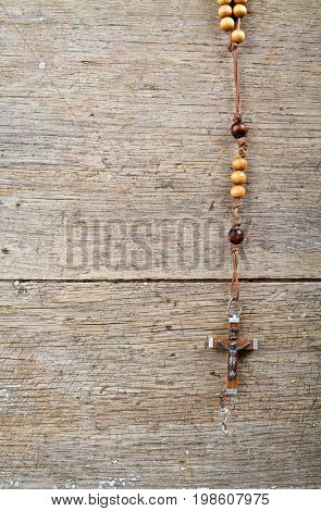 Rosary beads on the old wooden table