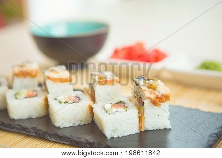 Sushi Roll With Salmon. Sushi Rolls On Black Slate Surface. Japanese Food