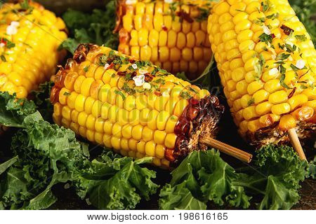 Corn Grilled With Salt And Spices. Dark Background. Fast Food In