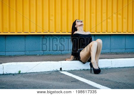 Gorgeous Brunette Girl With A Beautiful Make-up In Fashionable Clothes: A Black Blouse And Shorts Wi