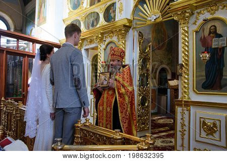 Alchevsk, Ukraine - April 28, 2017: Wedding Ceremony For Newlyweds In The Church