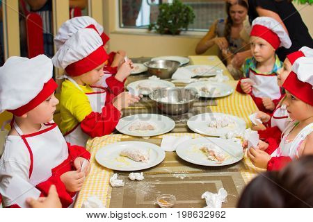 Alchevsk, Ukraine - July 23, 2017: School Cook For Children. Meat Rolls With Cheese Are Prepared.