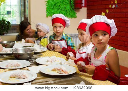 Alchevsk, Ukraine - July 23, 2017: School Cook For Children. Meat Rolls With Cheese Are Prepared.