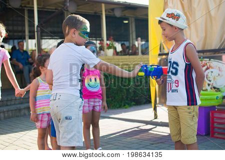 Alchevsk, Ukraine - July 27, 2017: Happy Children Play With Animators In Summer