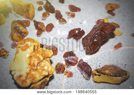 Amber. The Pieces Of Amber In The Sand On The Beach.