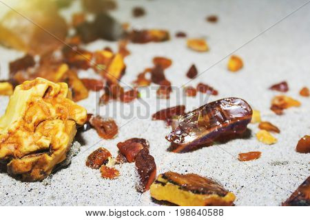 Amber. The Pieces Of Amber In The Sand On The Beach.