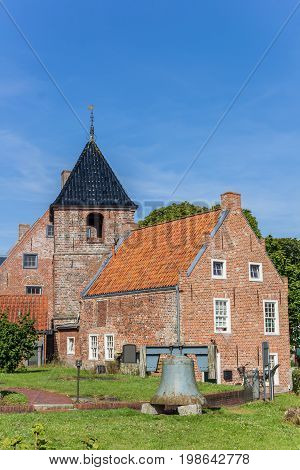 Church tower and historic house in Greetsiel Germany