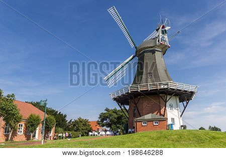 GREETSIEL, GERMANY - JULY 18, 2017: Windmills in the historic center of Greetsiel, Germany