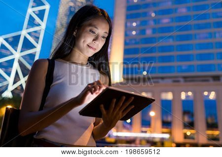 Woman use of digital tablet in the city
